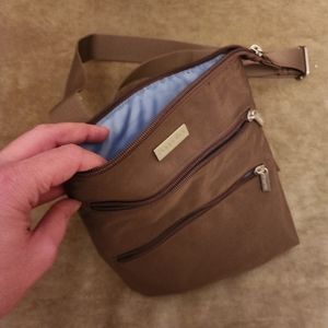 Brown, practical bag. Plenty of zippers, never been used. The straps are